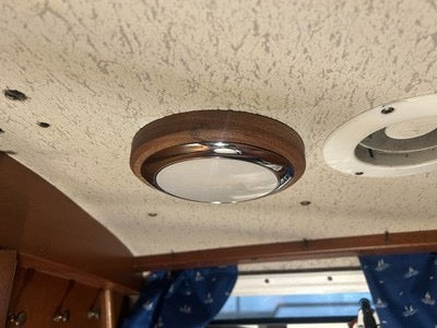 A ceiling light mounted on a beautifully finished sapele wood plinth, adding warmth and character to the chrome fixture. Made as a custom mounting base for installation on a yacht, it gives a clean and practical nautical finish.