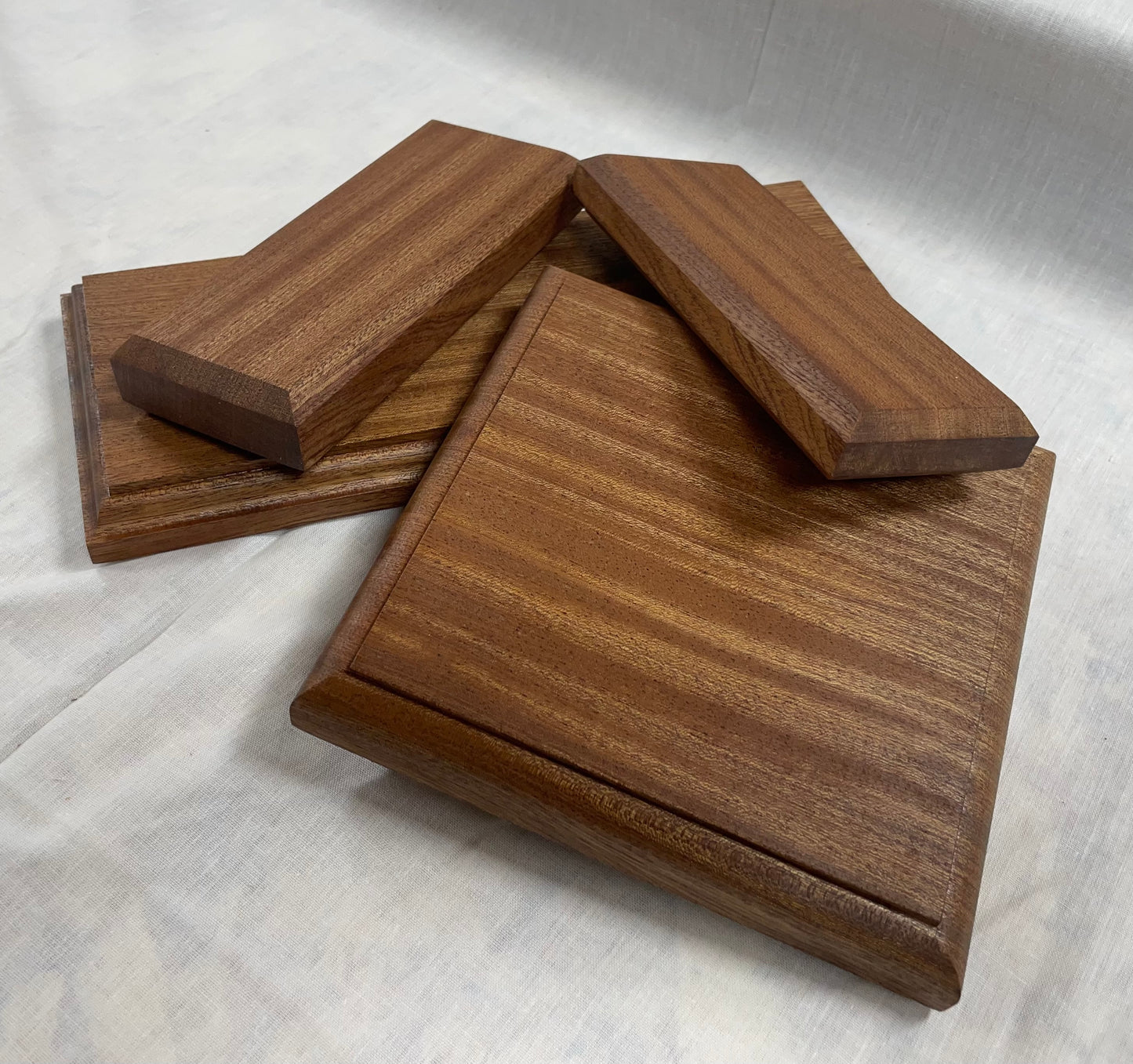 Close up of a variety of edges on mahogany display bases